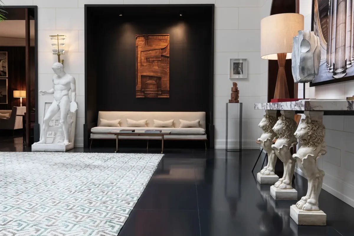 Classical statues mix with contemporary decor to fill the lobby of a stylish Rome hotel