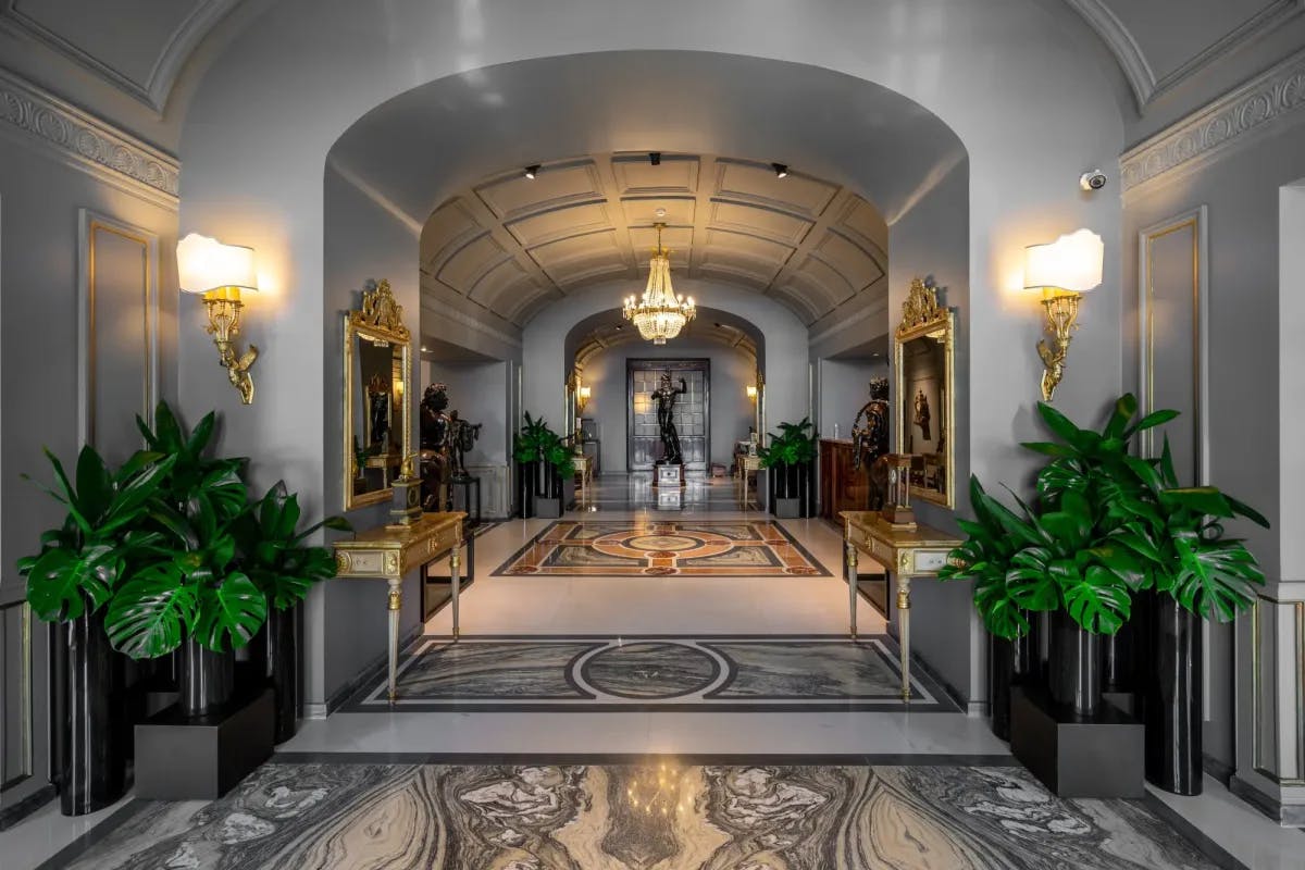 Ornate decor with neoclassical vibes fills the lobby of Grand Hotel Parker’s