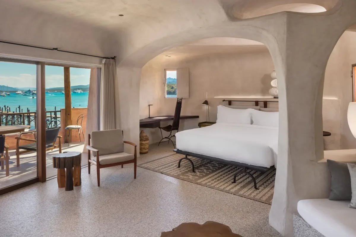 A stylish suite with stone walls and a marina and sea view.