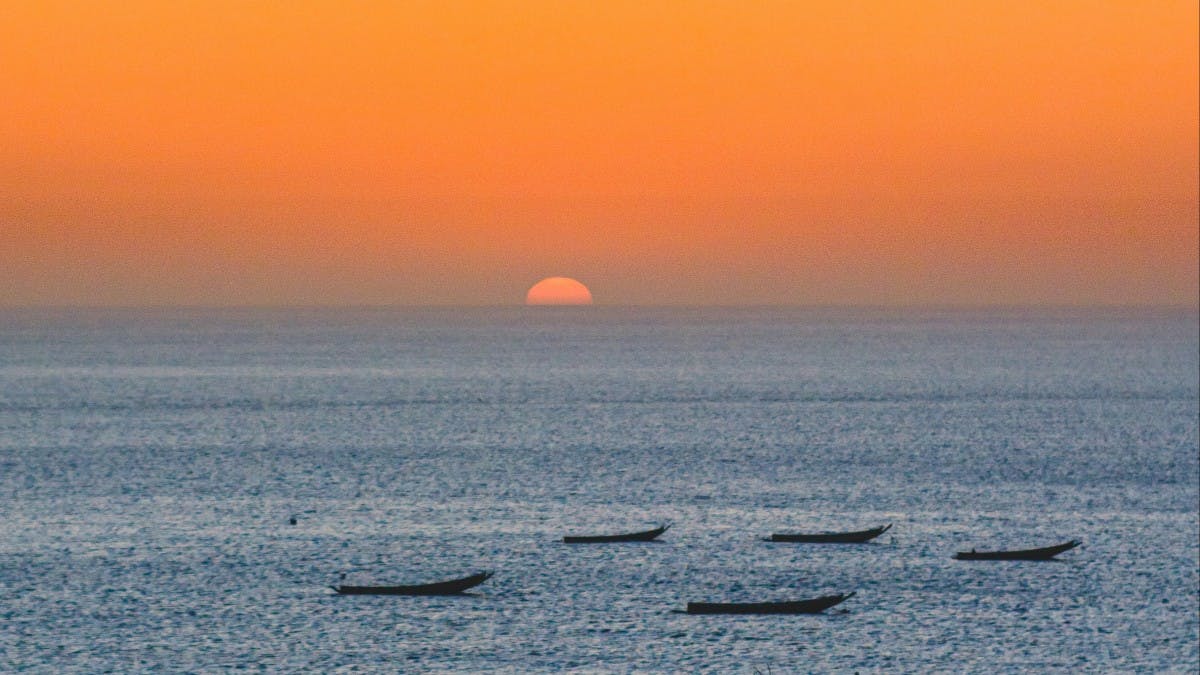 A beautiful sunset over a body of water in Senegal. 