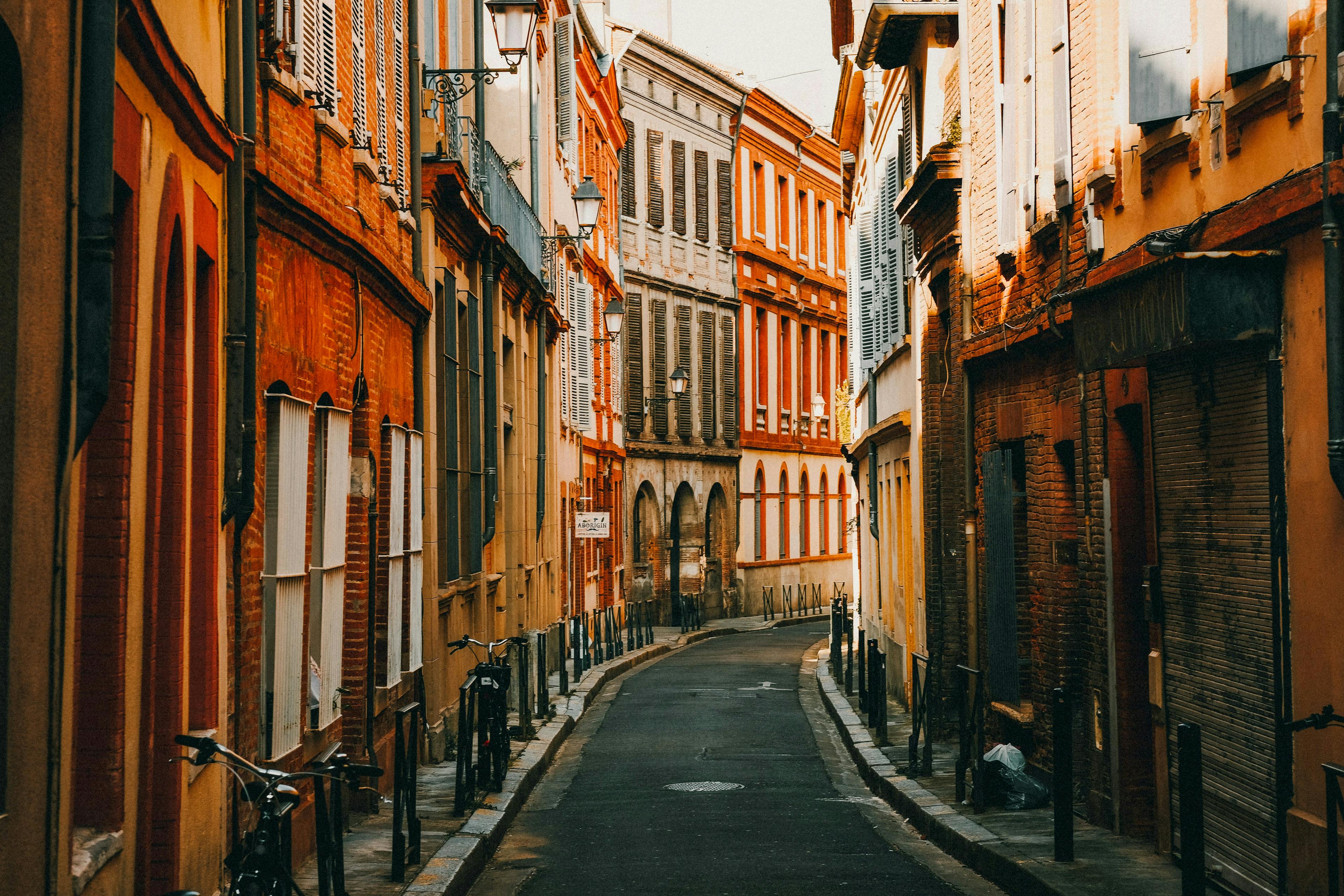 A curved brick city street in Toulouse. 