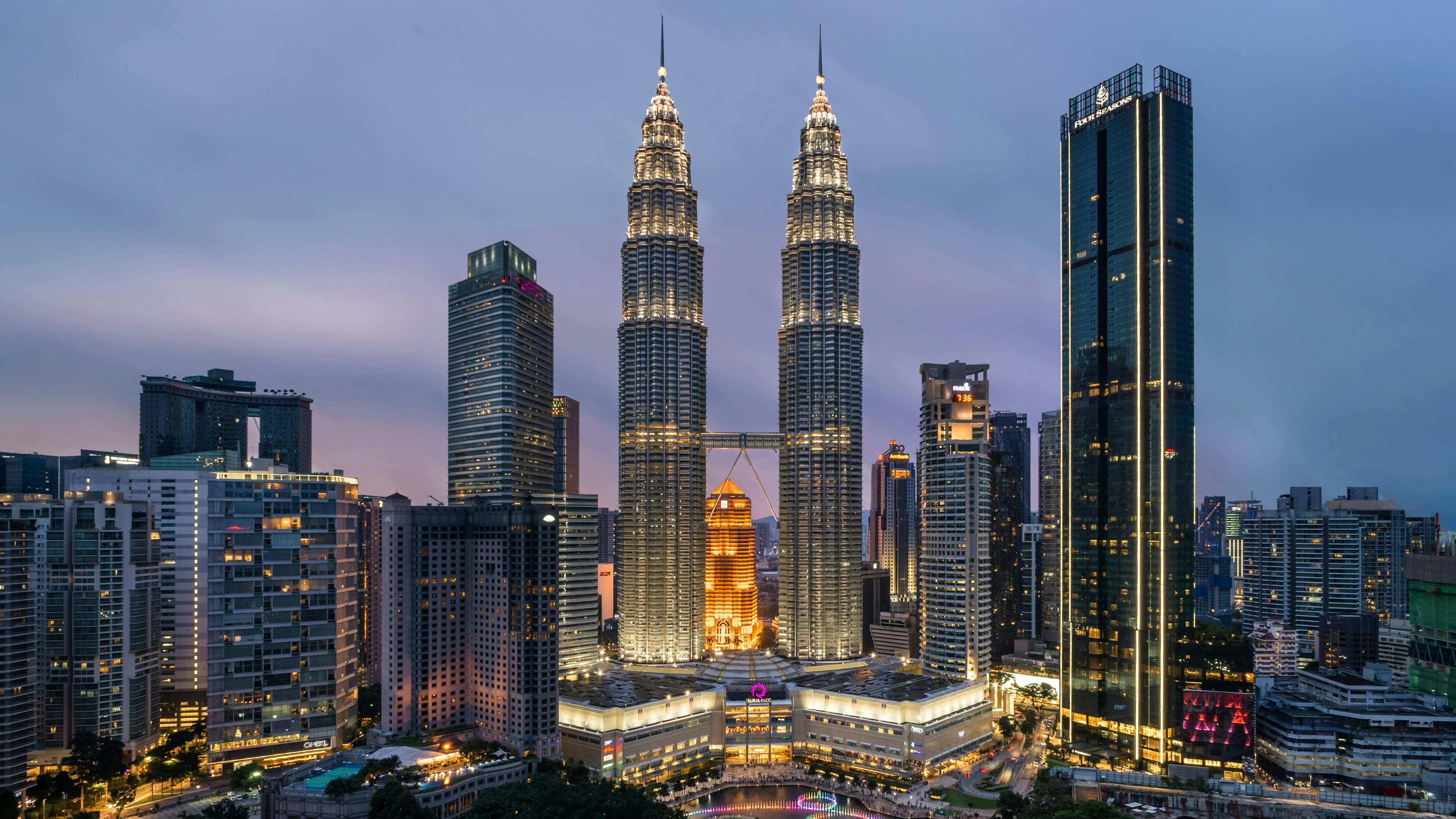 Kuala Lumpur skyline with the Petronas Twin Towers in the center at dusk